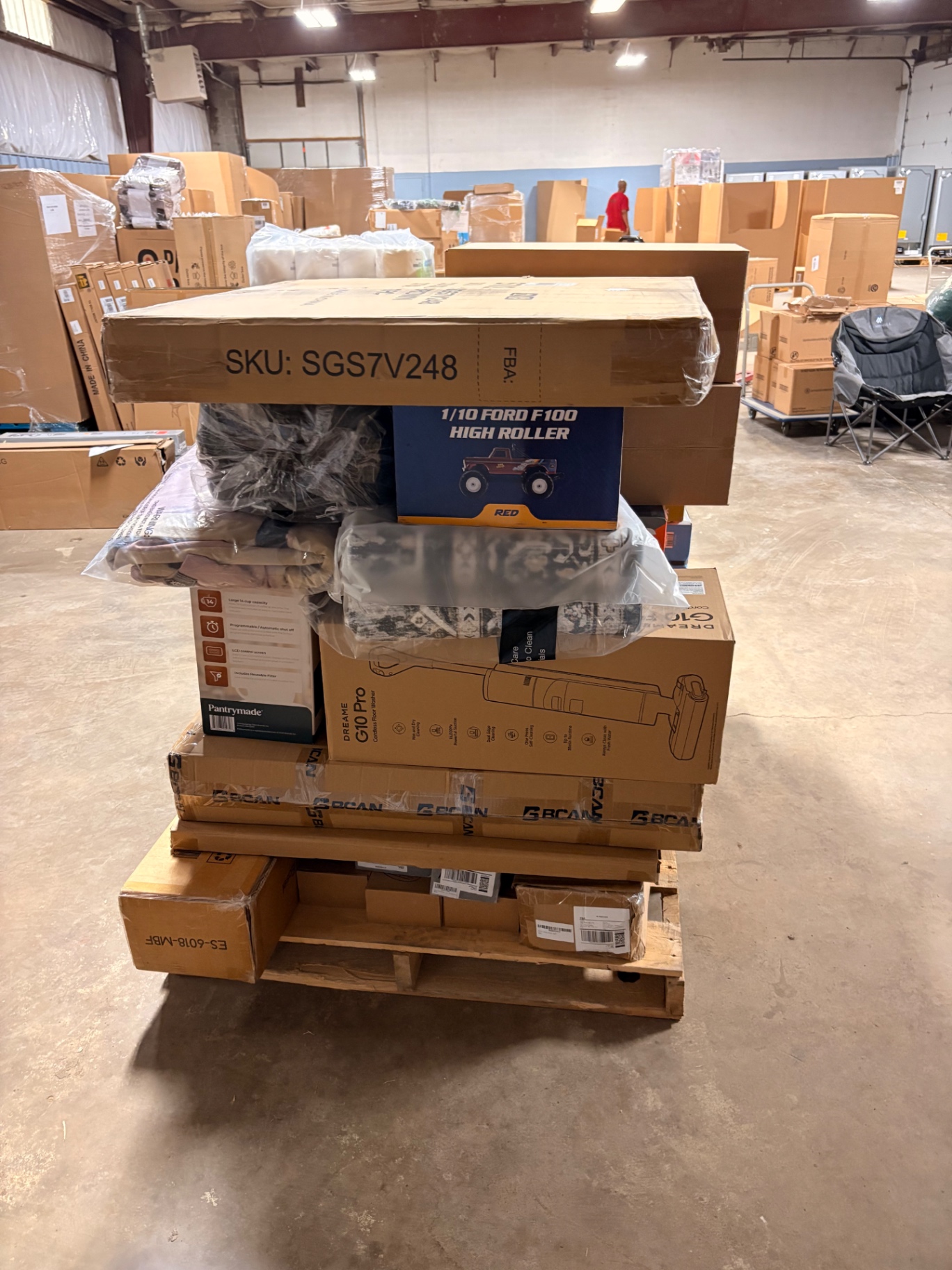 Mixed merchandise pallets and boxed inventory inside the Nest Pointe warehouse
