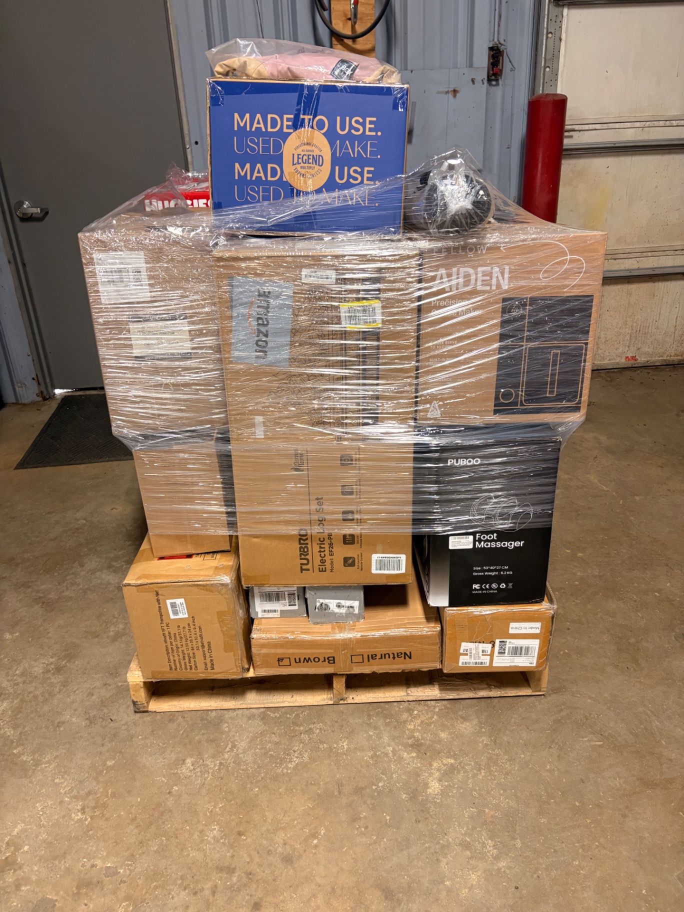 Mixed merchandise pallets and boxed inventory inside the Nest Pointe warehouse