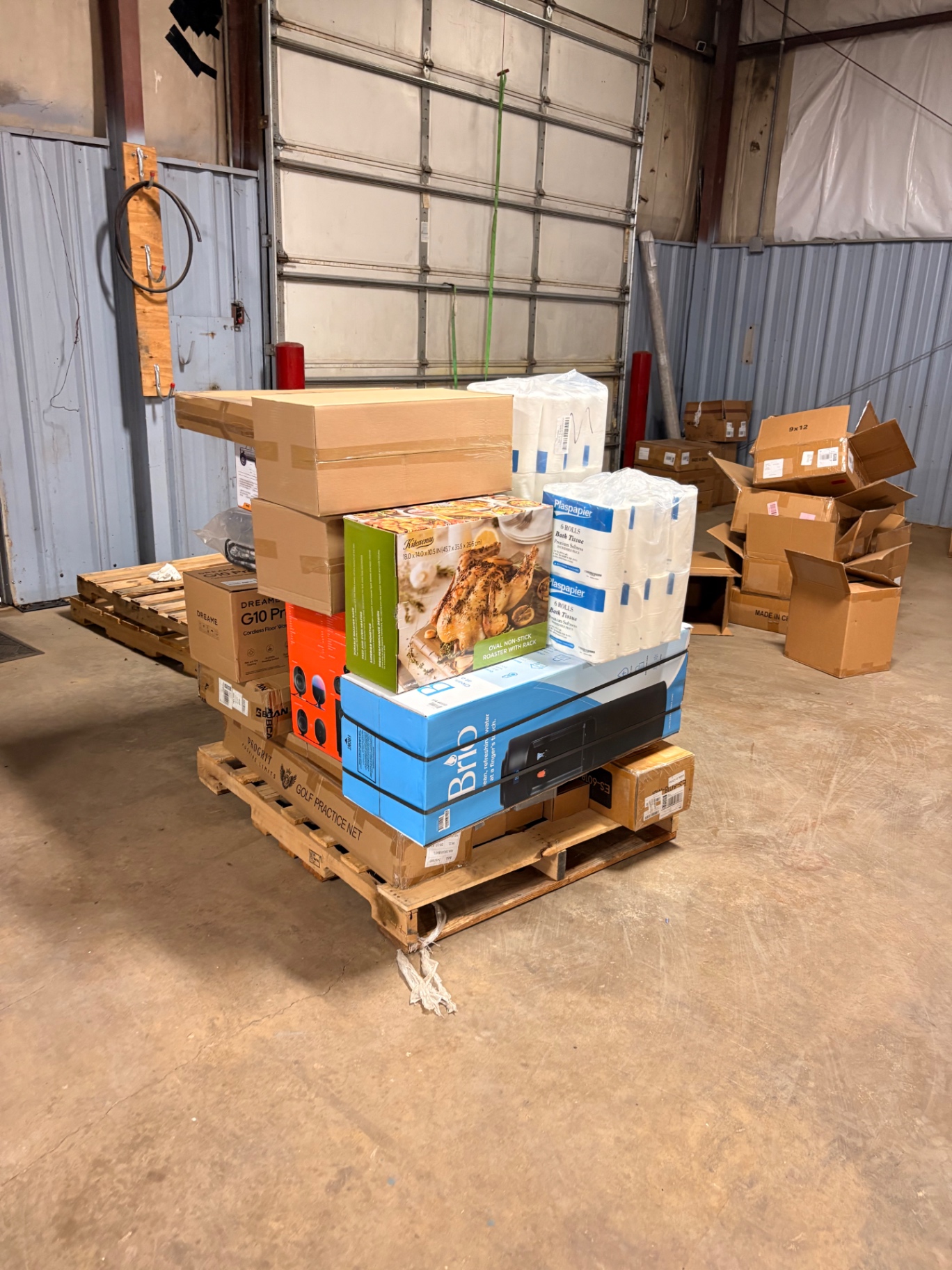 Mixed merchandise pallets and boxed inventory inside the Nest Pointe warehouse