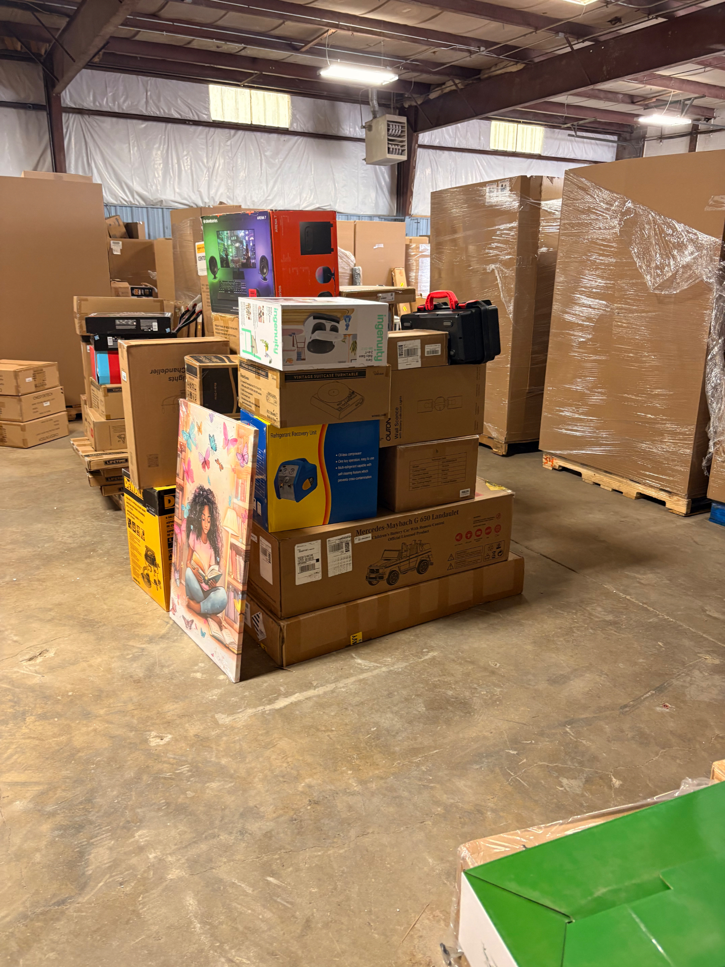 Shrink-wrapped pallets and boxed merchandise inside the Nest Pointe warehouse