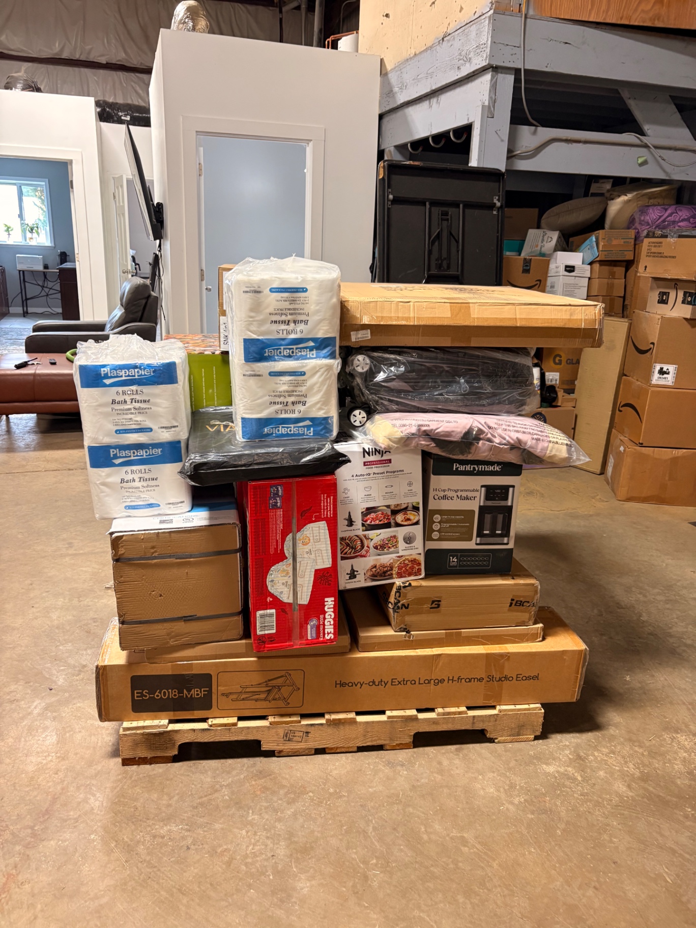 Mixed merchandise pallets and boxed inventory inside the Nest Pointe warehouse