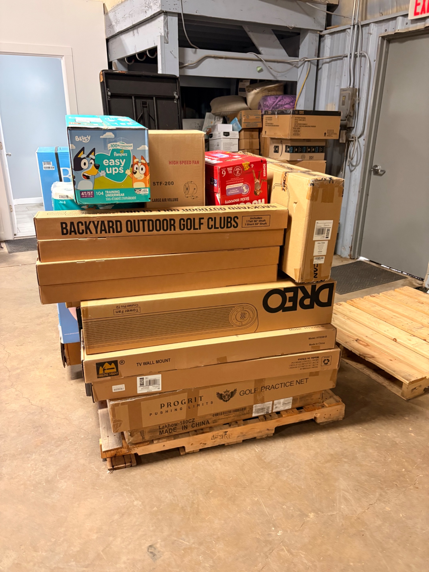 Mixed merchandise pallets and boxed inventory inside the Nest Pointe warehouse