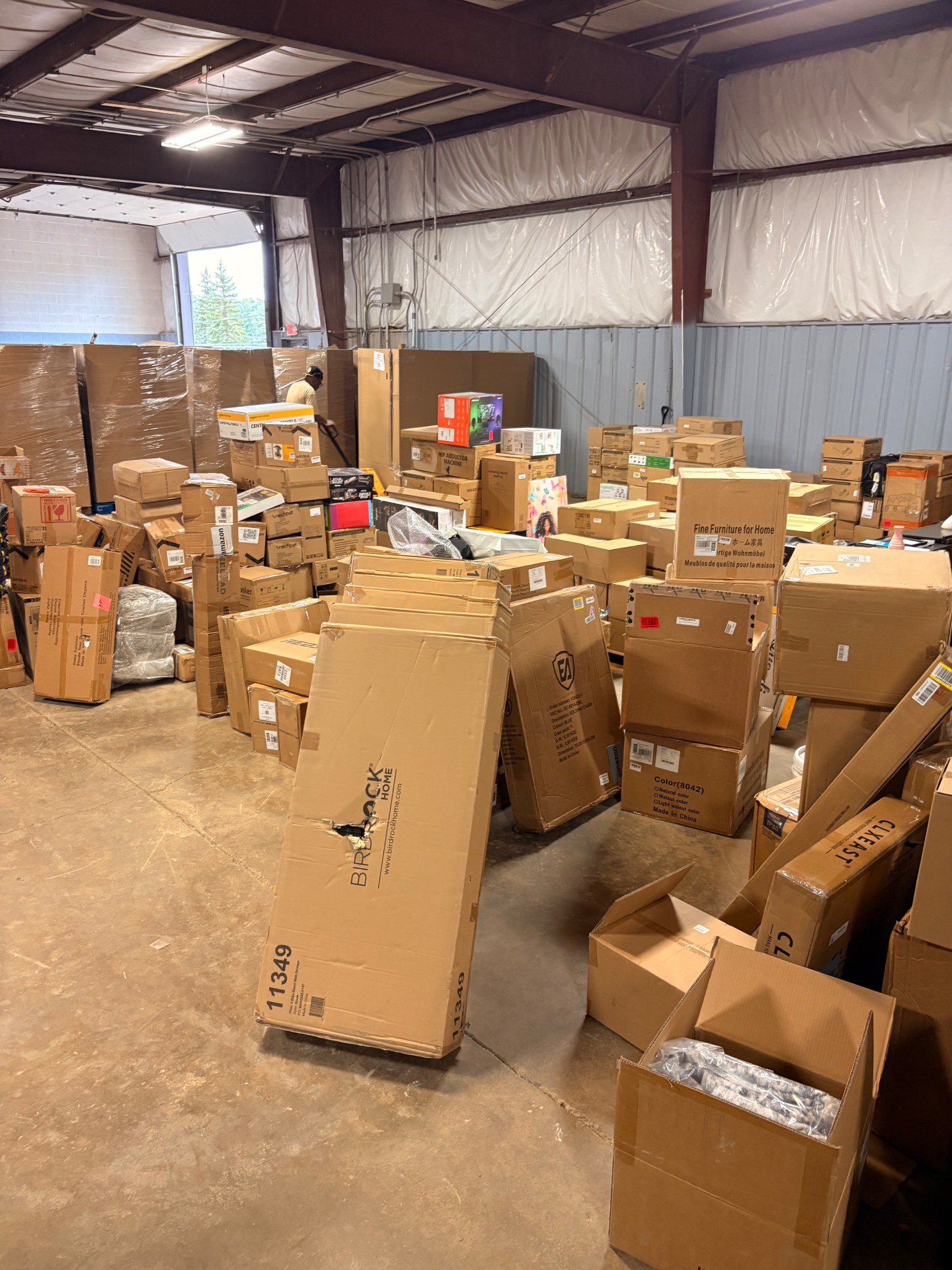 Mixed merchandise pallets and boxed inventory inside the Nest Pointe warehouse