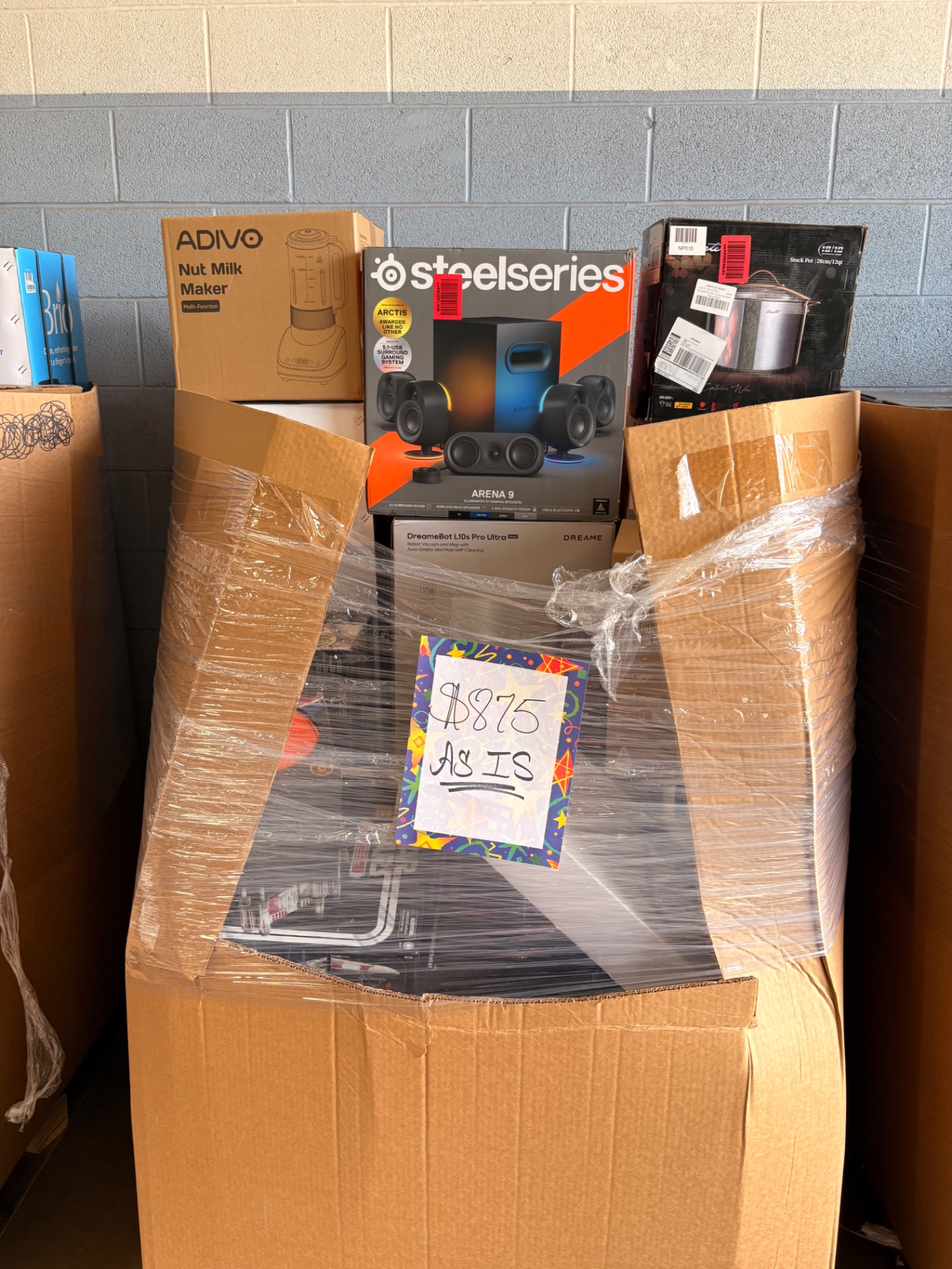 Boxed wholesale merchandise staged on the Nest Pointe warehouse floor