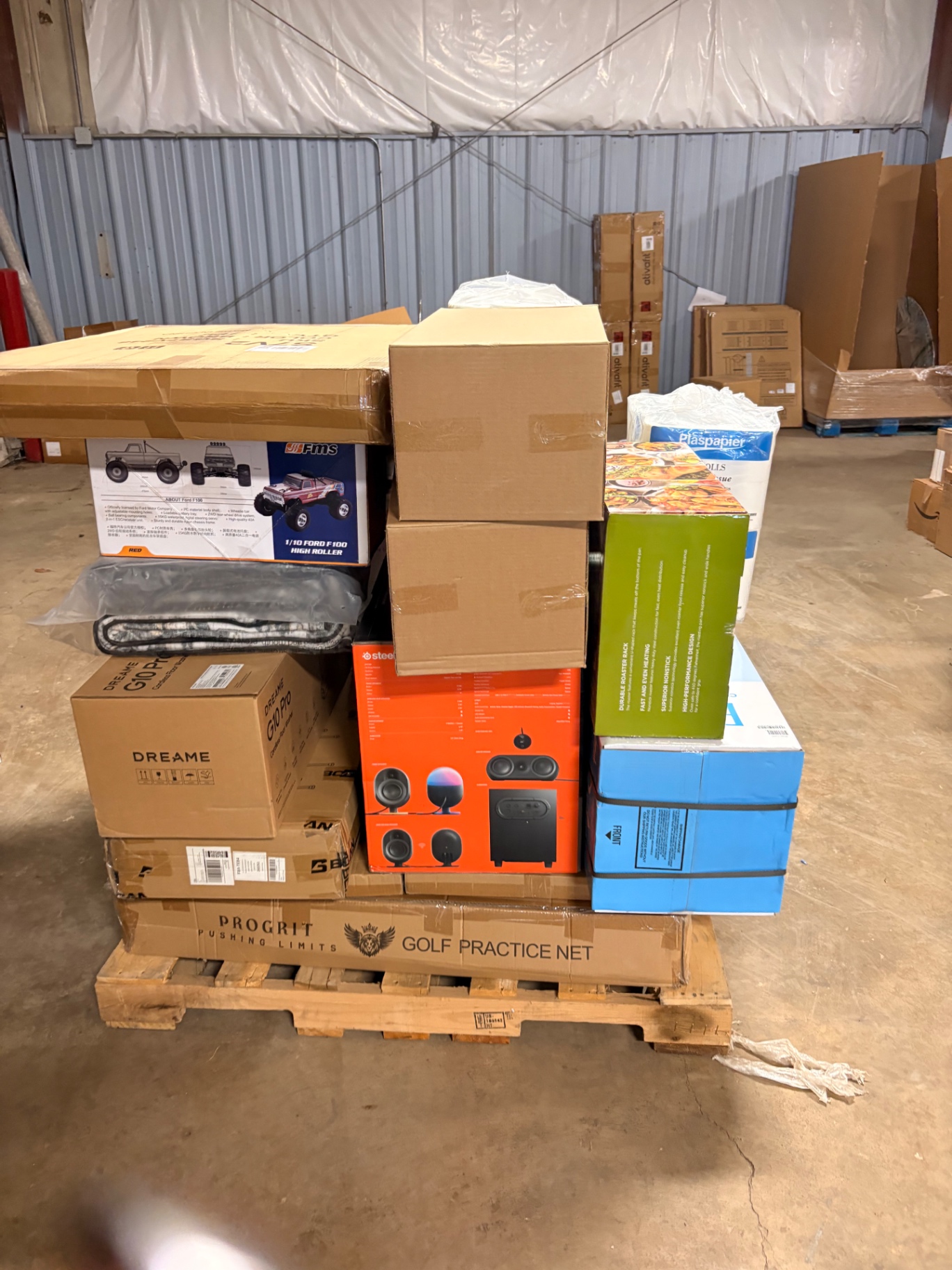 Mixed merchandise pallets and boxed inventory inside the Nest Pointe warehouse