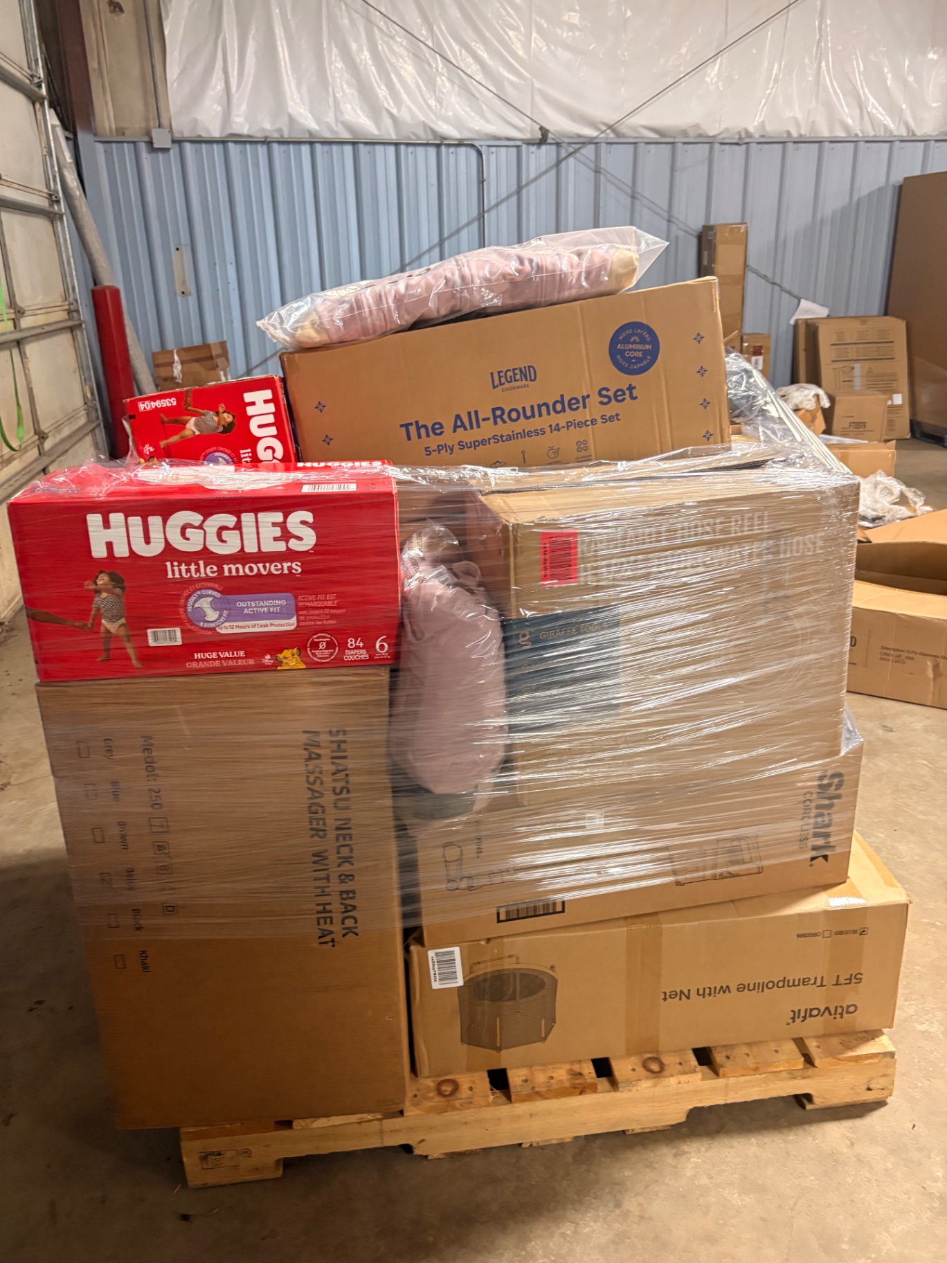 Mixed merchandise pallets and boxed inventory inside the Nest Pointe warehouse