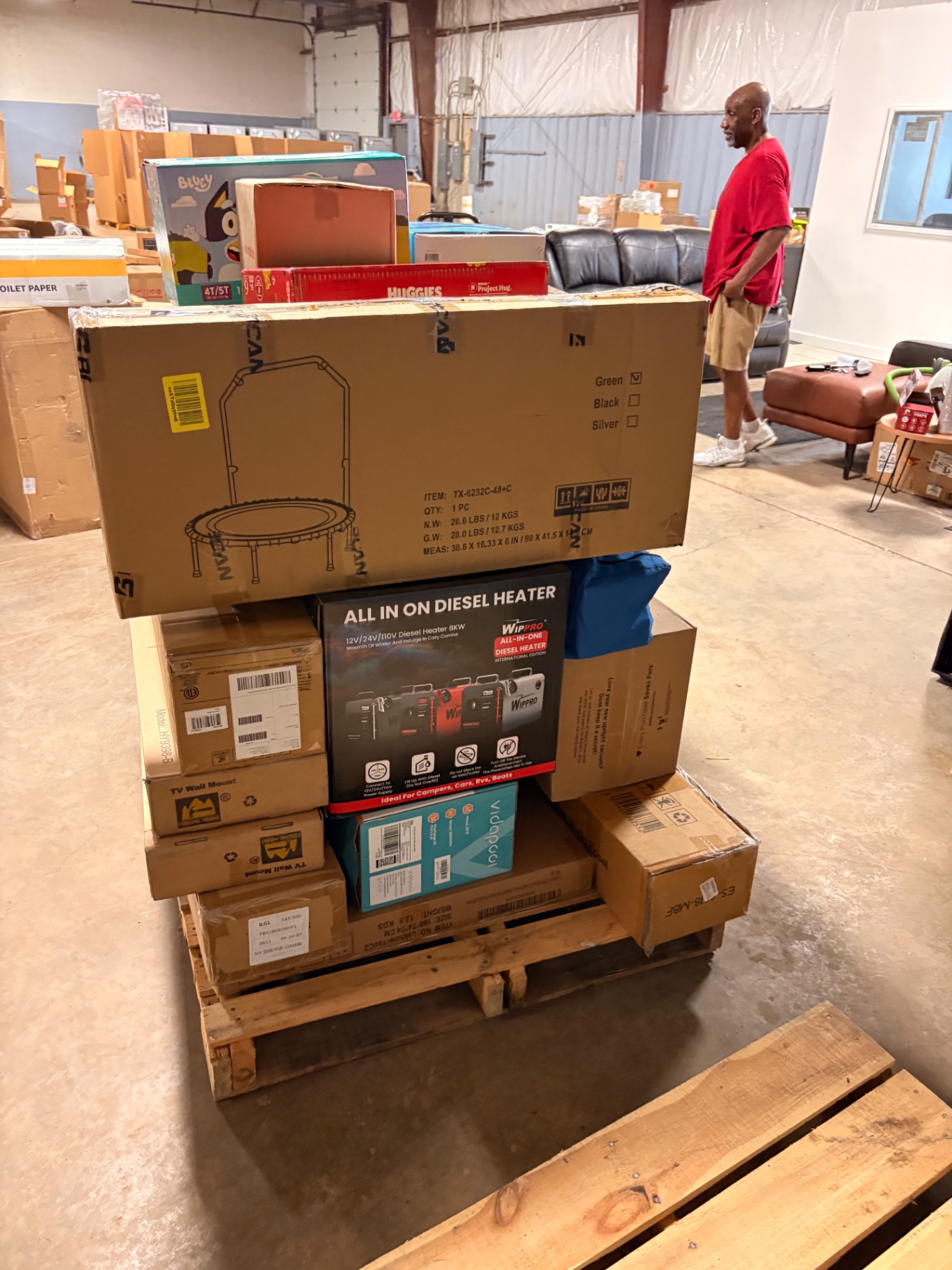 Mixed merchandise pallets and boxed inventory inside the Nest Pointe warehouse