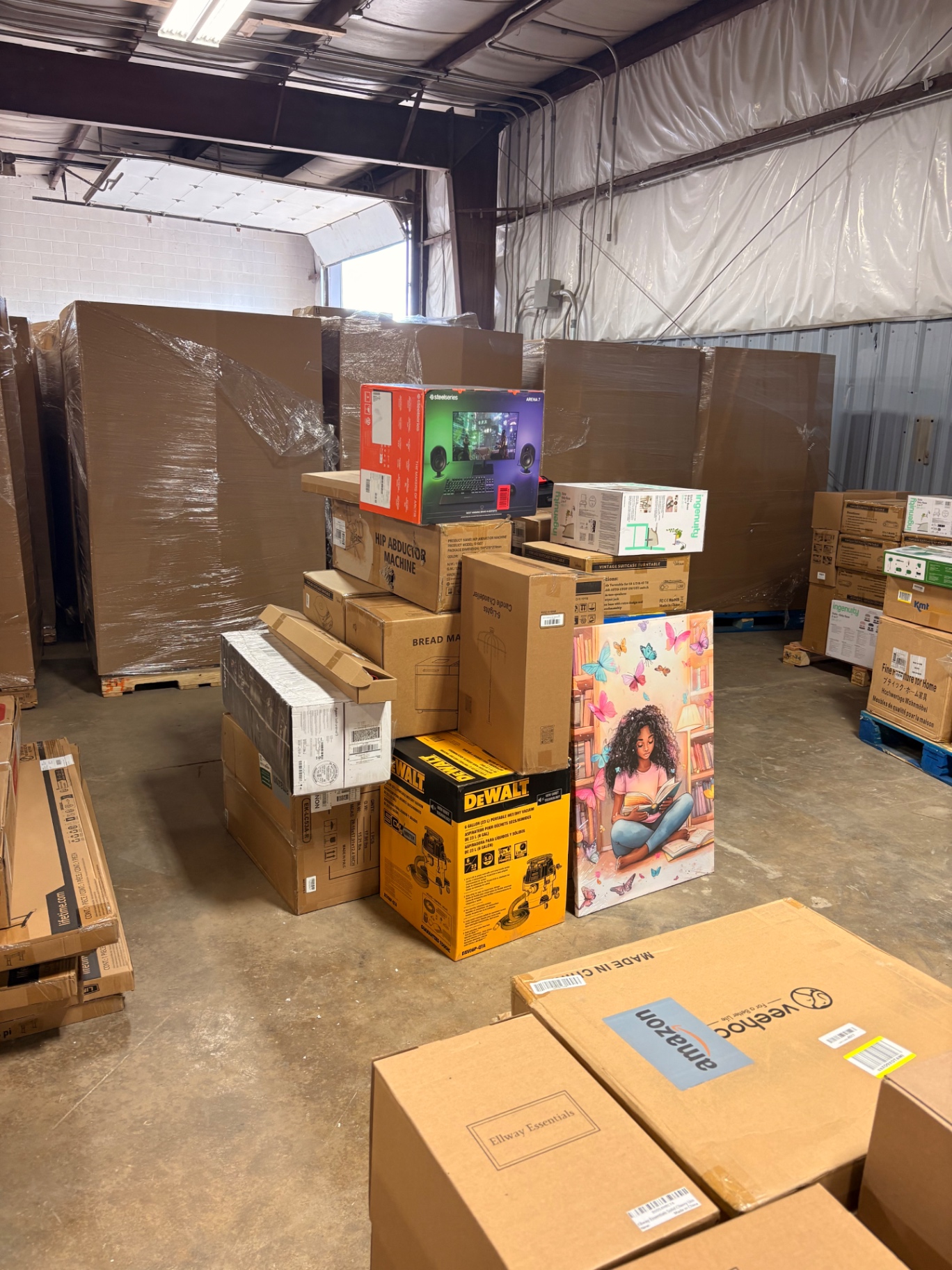 Shrink-wrapped pallets and boxed wholesale merchandise inside the Nest Pointe warehouse